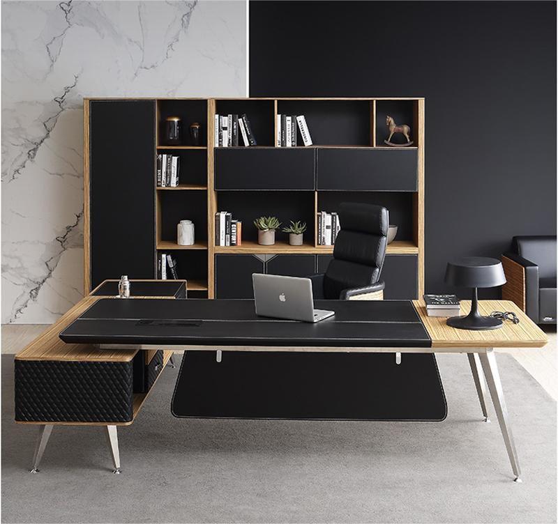 "A modern L-shaped executive desk with an inlaid black leather writing surface, zebrawood accents, silver metal legs, and a diamond-quilted side cabinet return."