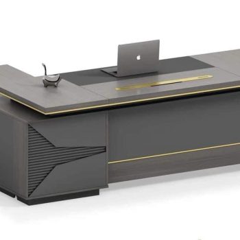 "A modern grey and charcoal executive desk featuring subtle gold trim, a black writing mat, and a matching side return cabinet."