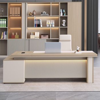 "A luxury contemporary L-shaped executive desk in light beige wood and cream, featuring an illuminated, vertically fluted modesty panel and a flush side return cabinet."