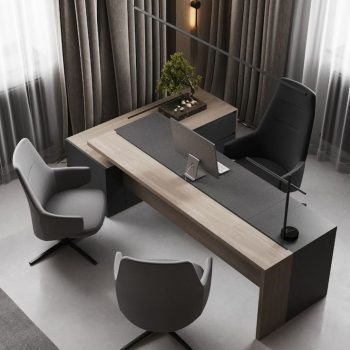 "An overhead view of a contemporary L-shaped executive desk featuring a two-tone top with a matte charcoal surface, a light wood grain accent border, and an integrated side credenza."