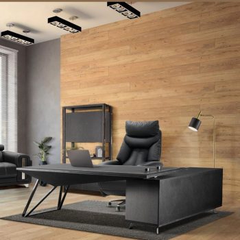 "A modern black L-shaped executive desk featuring a sharp, angled main top, a textured side return cabinet, and architectural black metal wireframe legs."