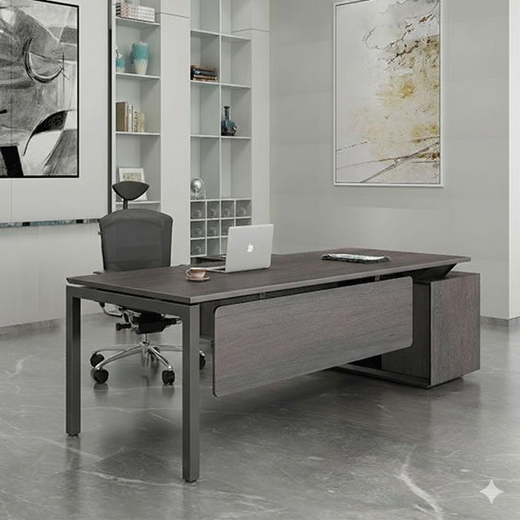 "A contemporary dark grey wood grain manager desk featuring a floating front modesty panel, slim dark metal legs, and an integrated side storage return."