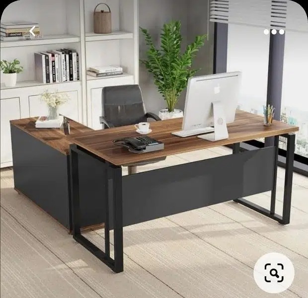 "An L-shaped manager desk with a dark walnut wood grain desktop, a matte charcoal black metal loop frame, and an attached charcoal black side storage return cabinet."