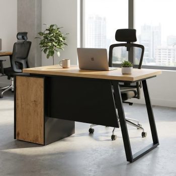 "A contemporary individual staff desk featuring a light oak wood desktop, an integrated black side storage cabinet with a rustic oak front accent, a suspended black modesty panel, and an angled matte black steel frame leg."