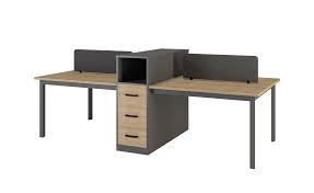"A modular back-to-back office workstation desk featuring warm wood-grain tops, a central charcoal gray storage divider with an integrated three-drawer pedestal, dark gray frame legs, and low-profile dark gray privacy screens."