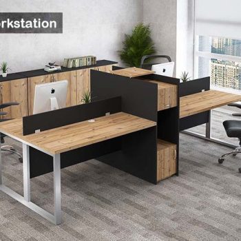"A modular 4-person back-to-back office workstation desk featuring natural wood-grain tabletops, silver metal O-shaped frame legs, black privacy divider screens, and a tall central black spine cabinet with integrated wood-grain storage units."