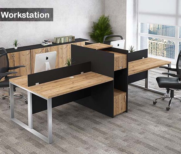 "A modular 4-person back-to-back office workstation desk featuring natural wood-grain tabletops, silver metal O-shaped frame legs, black privacy divider screens, and a tall central black spine cabinet with integrated wood-grain storage units."