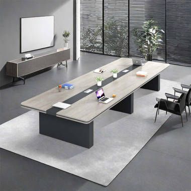 "A long, rectangular executive boardroom desk featuring a light grey wood-grain top with a recessed charcoal-grey center media track, supported by two thick, matte charcoal-grey pedestal bases."