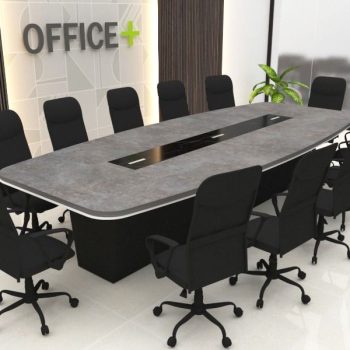 "A large, modern conference room meeting table featuring a rounded rectangular concrete-gray top with a contrasting black glass center media track and a thick black box pedestal base."
