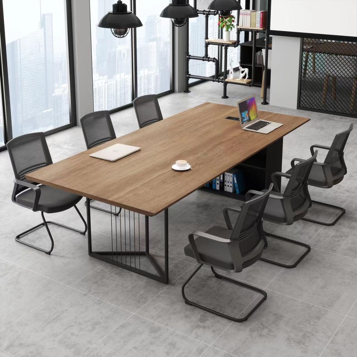 "A modern industrial rectangular conference meeting table featuring a warm oak wood-grain tabletop with a black pop-up power outlet, supported by an open black metal geometric frame leg with vertical wire accent bars on one end and a black storage credenza base on the other."