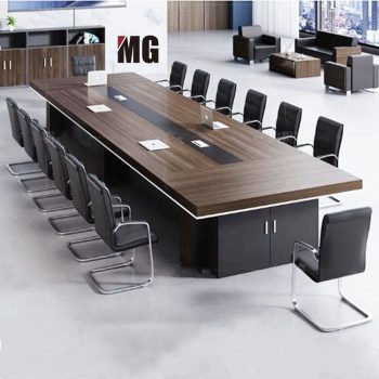 "A massive, rectangular executive conference desk featuring a thick dark walnut wood-grain top with a white under-edge accent trim, a continuous black center media channel with power flaps, and a heavy black credenza storage base."