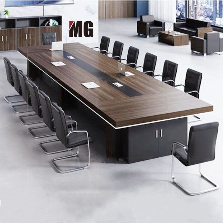 "A massive, rectangular executive conference desk featuring a thick dark walnut wood-grain top with a white under-edge accent trim, a continuous black center media channel with power flaps, and a heavy black credenza storage base."