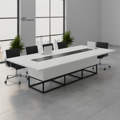 "A large, modern white conference room meeting table featuring a rounded rectangular tabletop with a long, recessed black center media track, a chunky white box-style base, and an open black metal geometric frame support."