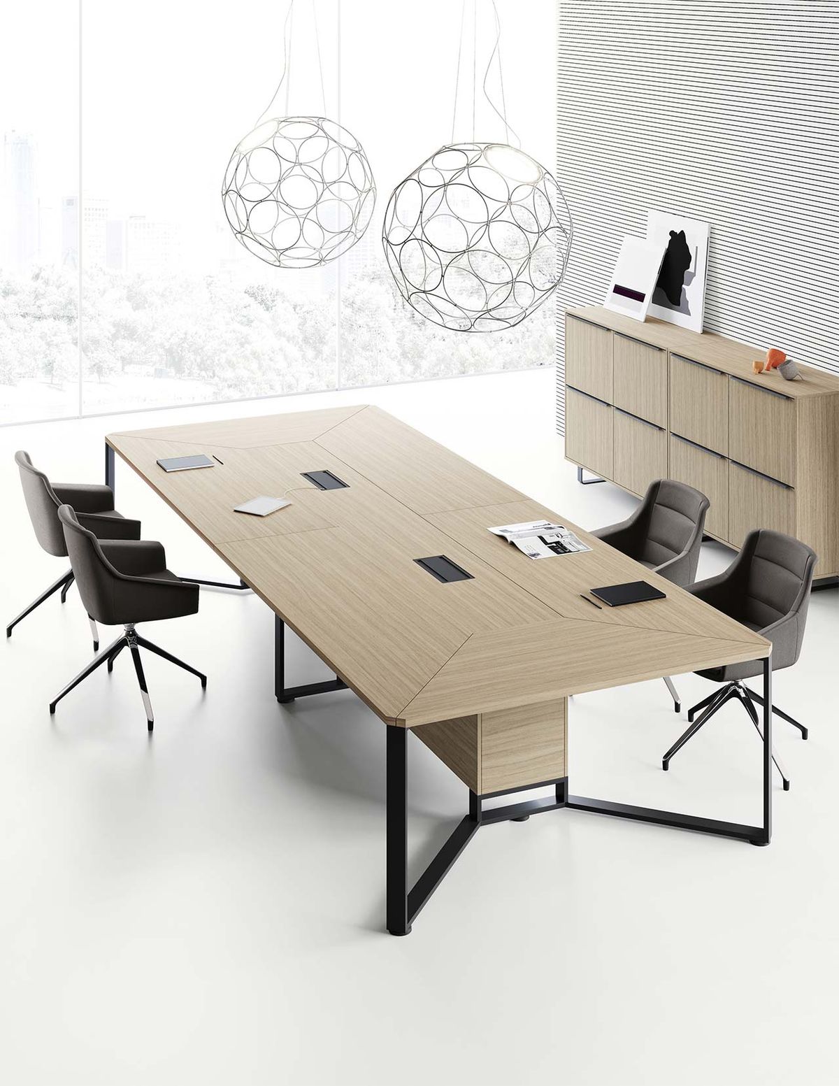 "A modern rectangular executive boardroom desk featuring a light oak wood-grain top with geometric mitered-edge detailing, two black pop-up power outlets, and a sculptural black metal open-frame base."