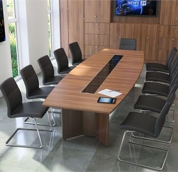 "A large, boat-shaped executive conference desk featuring a warm natural wood-grain top accented by a long, glossy black glass center media track, supported by integrated cross-shaped wood panel pedestal legs."