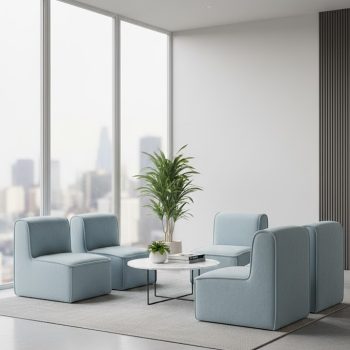 "A contemporary modular lounge set featuring four armless, low-profile chairs in a light powder blue fabric with rounded edges and visible piping detail."